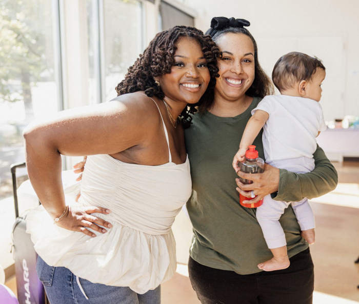 Leslie Coney with a shower attendee holding a child